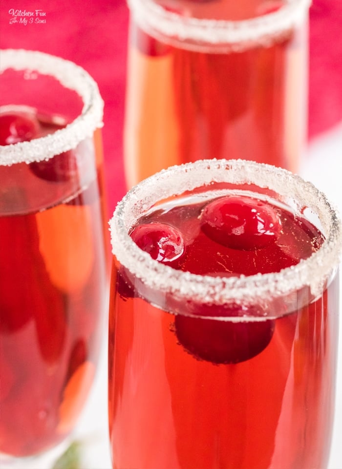 A Cranberry Mimosa is a delicious and easy Christmas cocktail. With a bright red color and sparkly sugar rim, it is so pretty and festive for the holidays.