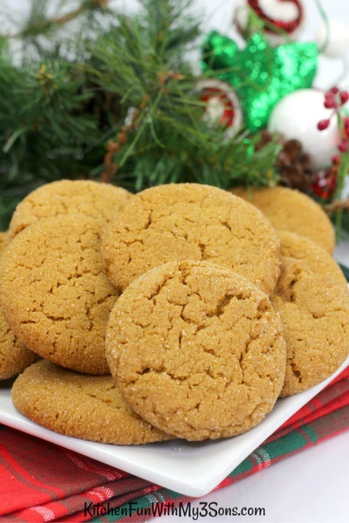 Ginger snap cookies on a white plate with holiday decorations