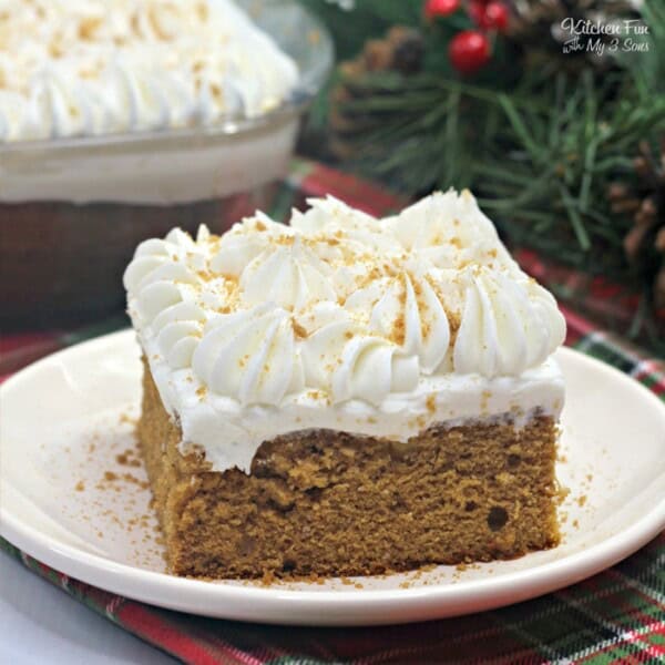 Gingerbread Poke Cake is a tasty spice cake recipe with molasses and filled with sweetened condensed milk. All topped off with whipped cream and gingerbread cookies!
