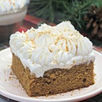 Ginger cake with a whipped cream topping and crushed ginger cookies.