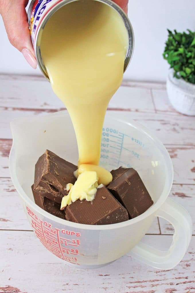 Condensed Milk being poured over Chocolate
