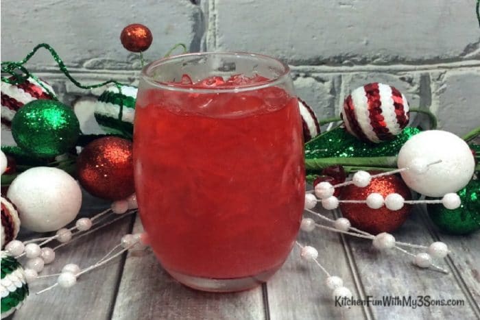 Jolly Holiday Punch in glass with holiday decorations in background