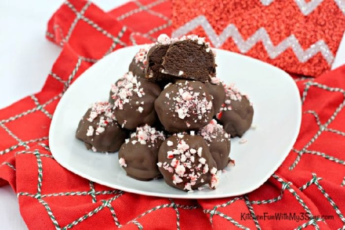 Peppermint brownie truffles on a white plate sitting on red napkin