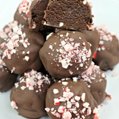 Peppermint brownie truffles stacked on a white plate
