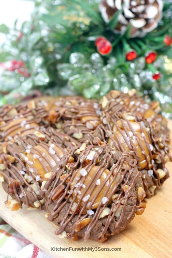 Stacked turtle cookies with pecans and drizzled chocolate on top