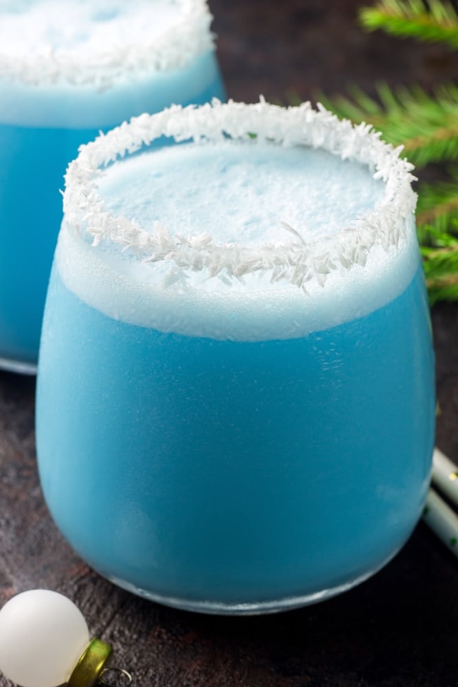 Close up of a Jack Frost Cocktail with a coconut rim