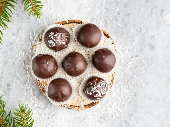 Chocolate Covered Coconut Bon Bons on a wood plate