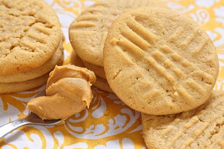 Peanut butter cookies on a yellow and white table cloth
