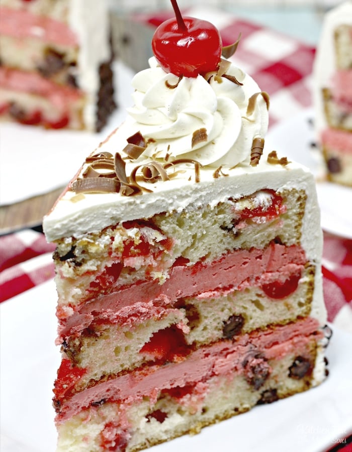 Cherry Garcia Cake is stacked with layers of vanilla cherry cake and homemade cherry icing. This cake looks like it came straight from a bakery!