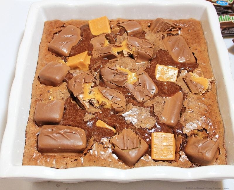 Milky Way candy bars on top of brownies