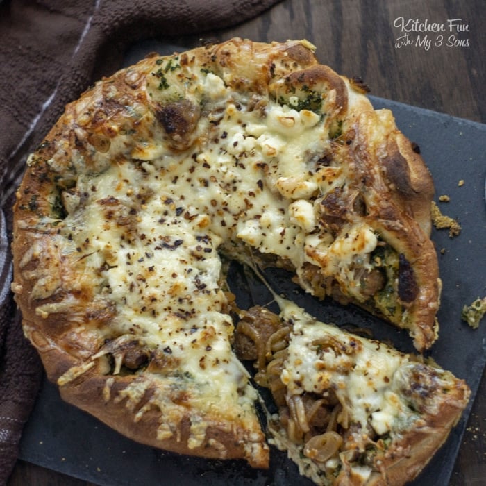 Pesto Pizza with sausage and kale is a delicious homemade pizza recipe. You can make this for lunch, dinner or make a couple as a great appetizer at a party!