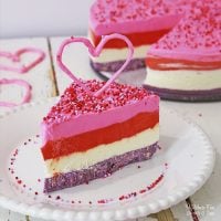 Valentines Cheesecake is a triple layer dessert with a cookie crust. It's easy to make, it's no-bake, and it's frozen, so you can make it ahead and serve it when you're ready.