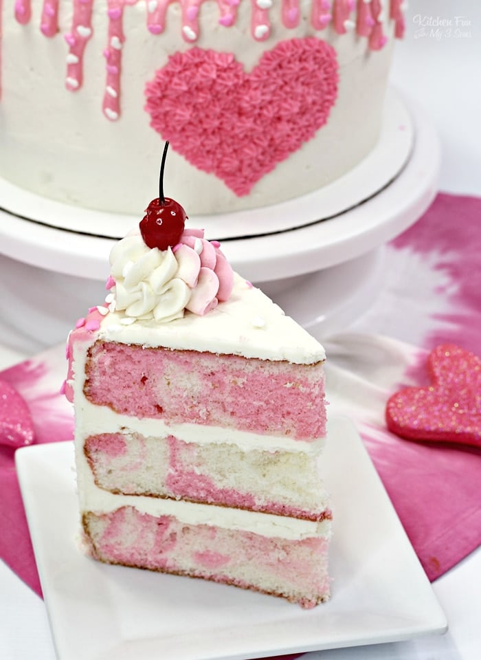 Our Valentines Day Cake is absolutely beautiful and super tasty! It's a triple layer pink and white cake with homemade vanilla frosting on top.