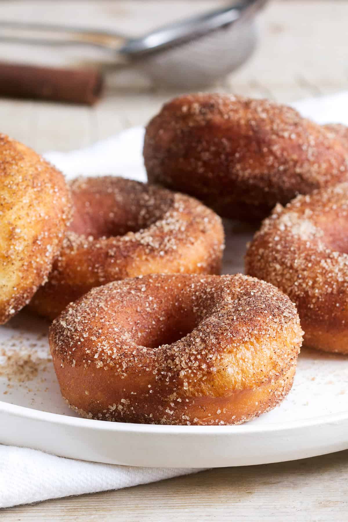 Air Fryer Donuts that are made from refrigerated biscuits! Just 4-ingredients and 5-minutes to make. Air Fryer Donuts on a plate