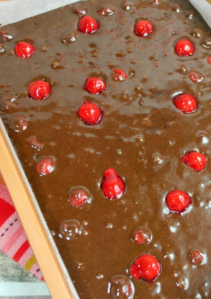 These Black Forest Brownies are rich chocolate brownies combined with cherry pie filling and then topped with a fudgy chocolate ganache! brownie batter and cherry pie filling ready to be baked