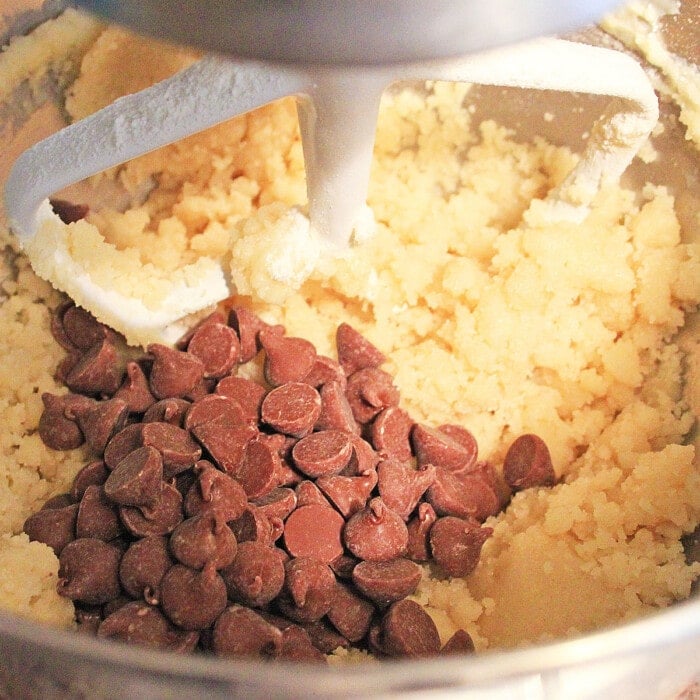 adding chocolate chips into the butter and sugar mixture