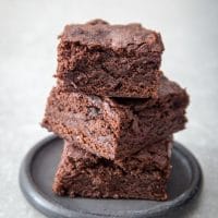 Dr Pepper Brownies Stacked on a plate.