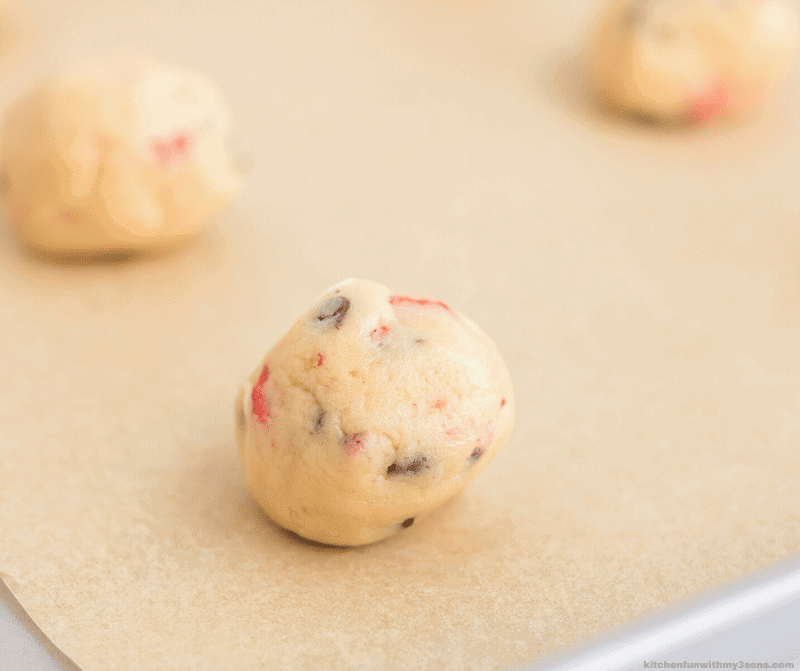 a white chocolate strawberry cheesecake cookie dough ball up close
