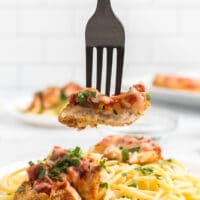A bite of chicken parmesan on a fork