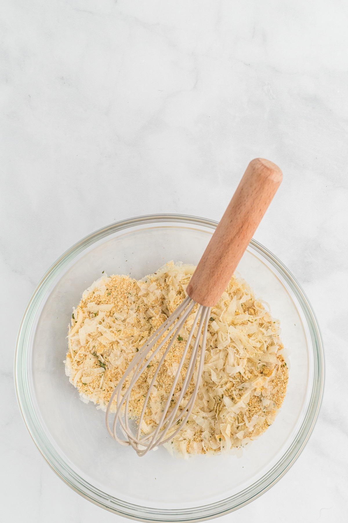 Breadcrumbs, cheese, and seasonings whisked together in a bowl