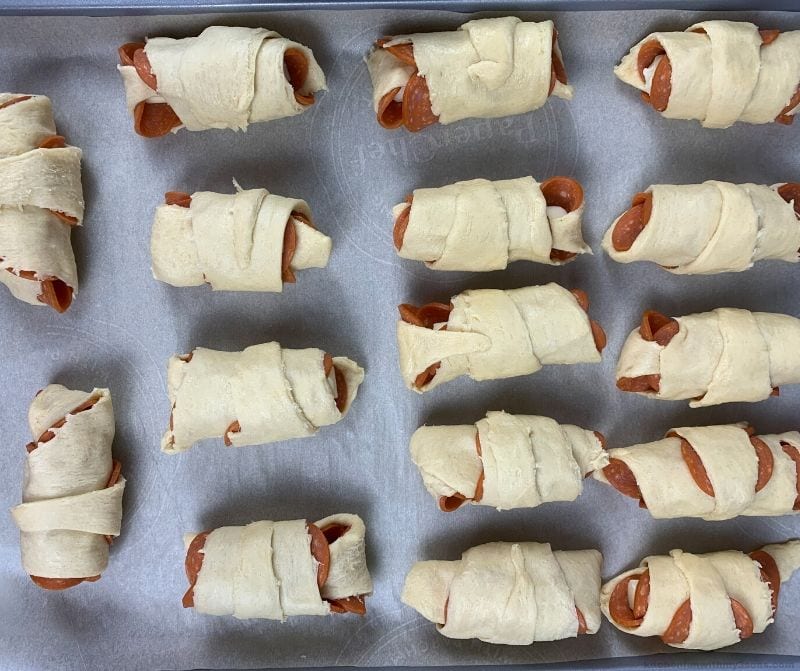 Croissant Homemade Pizza Rolls unbaked on a cookie sheet