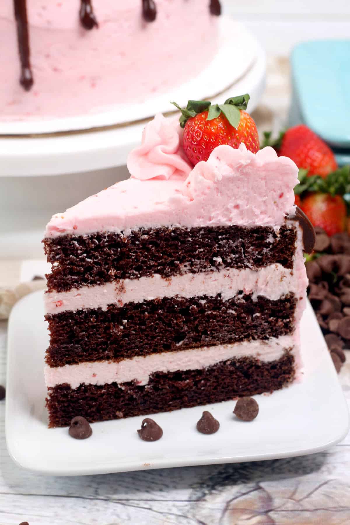 A slice of chocolate strawberry cake on a white plate