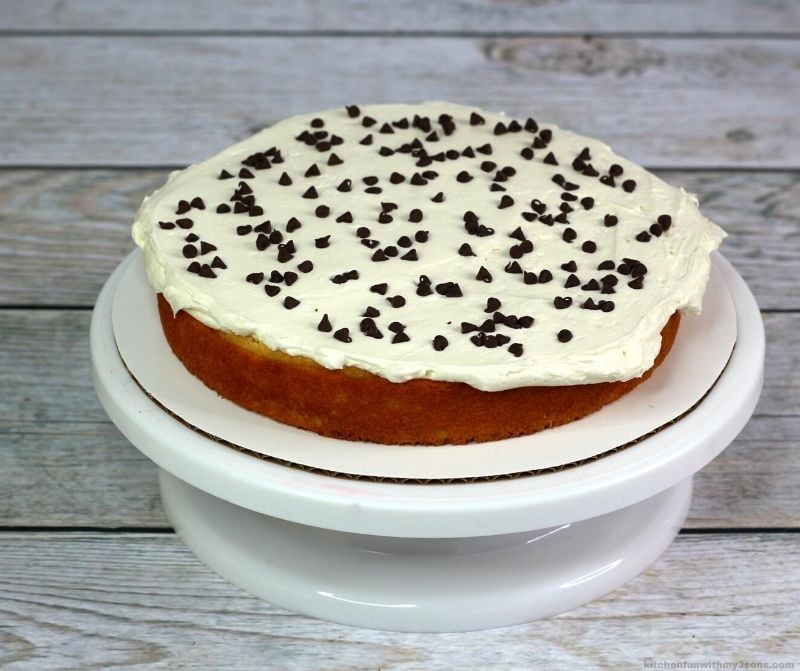 cake layer with frosting and chocolate chips