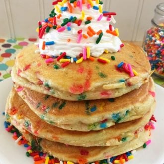 Rainbow Funfetti Pancakes on a white plate