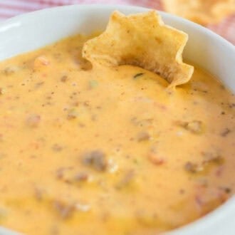 A bowl of hamburger dip with a tortilla chip