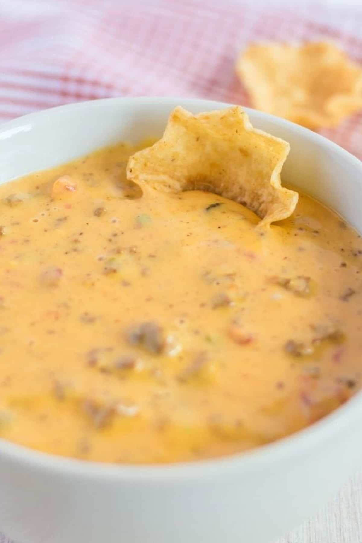 A bowl of hamburger dip with a tortilla chip
