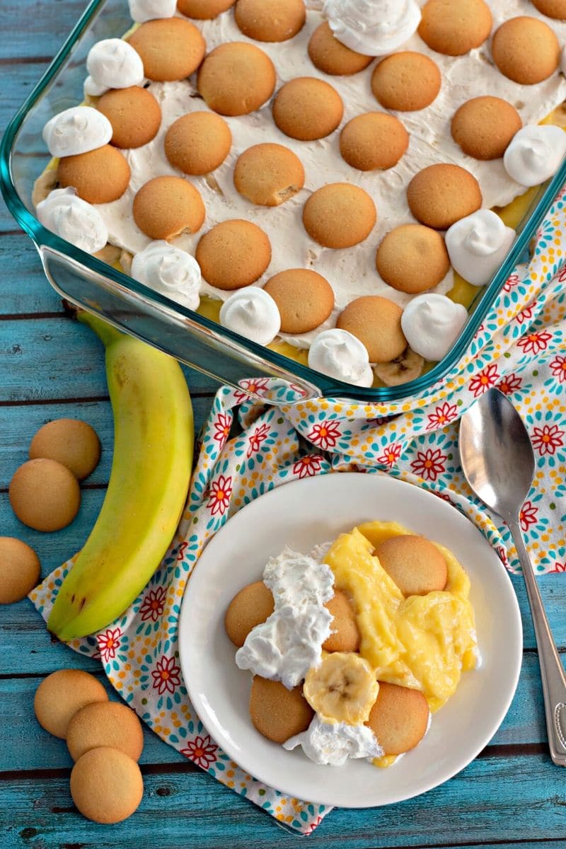 Nilla wafer banana pudding in a glass dish, with a serving on a plate.