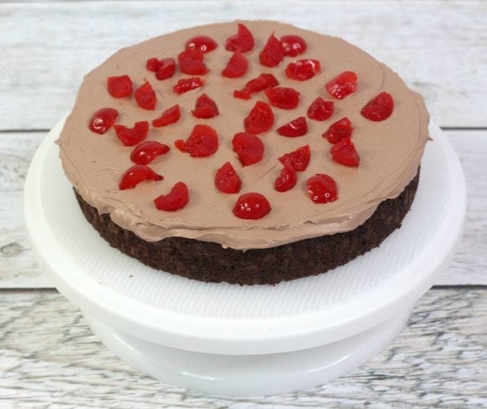 chocolate cake with chocolate frosting and cherries