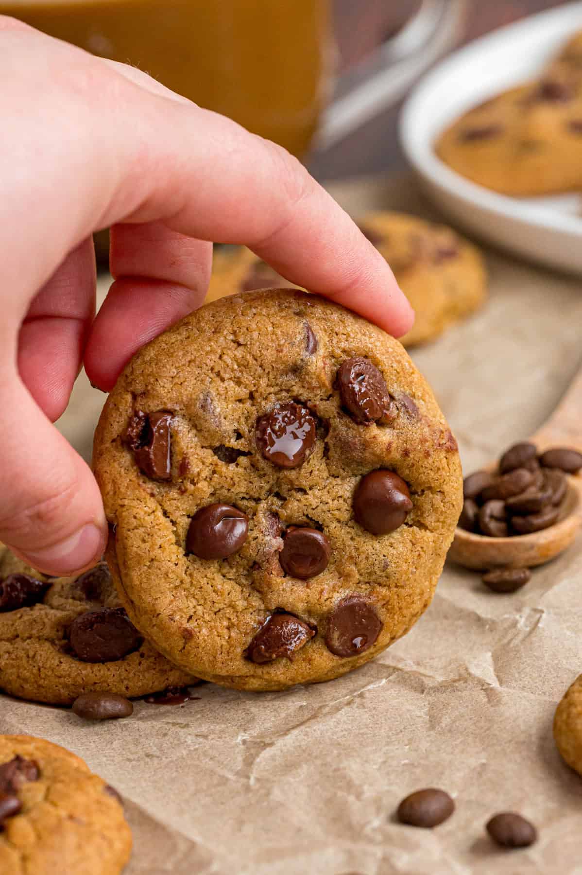 A hand holding a coffee cookie