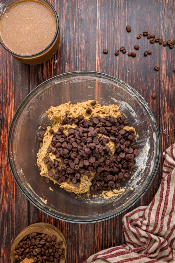 Adding chocolate chips to cookie dough