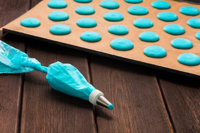Piping Blue Macaron Mixture onto Cookie Sheet