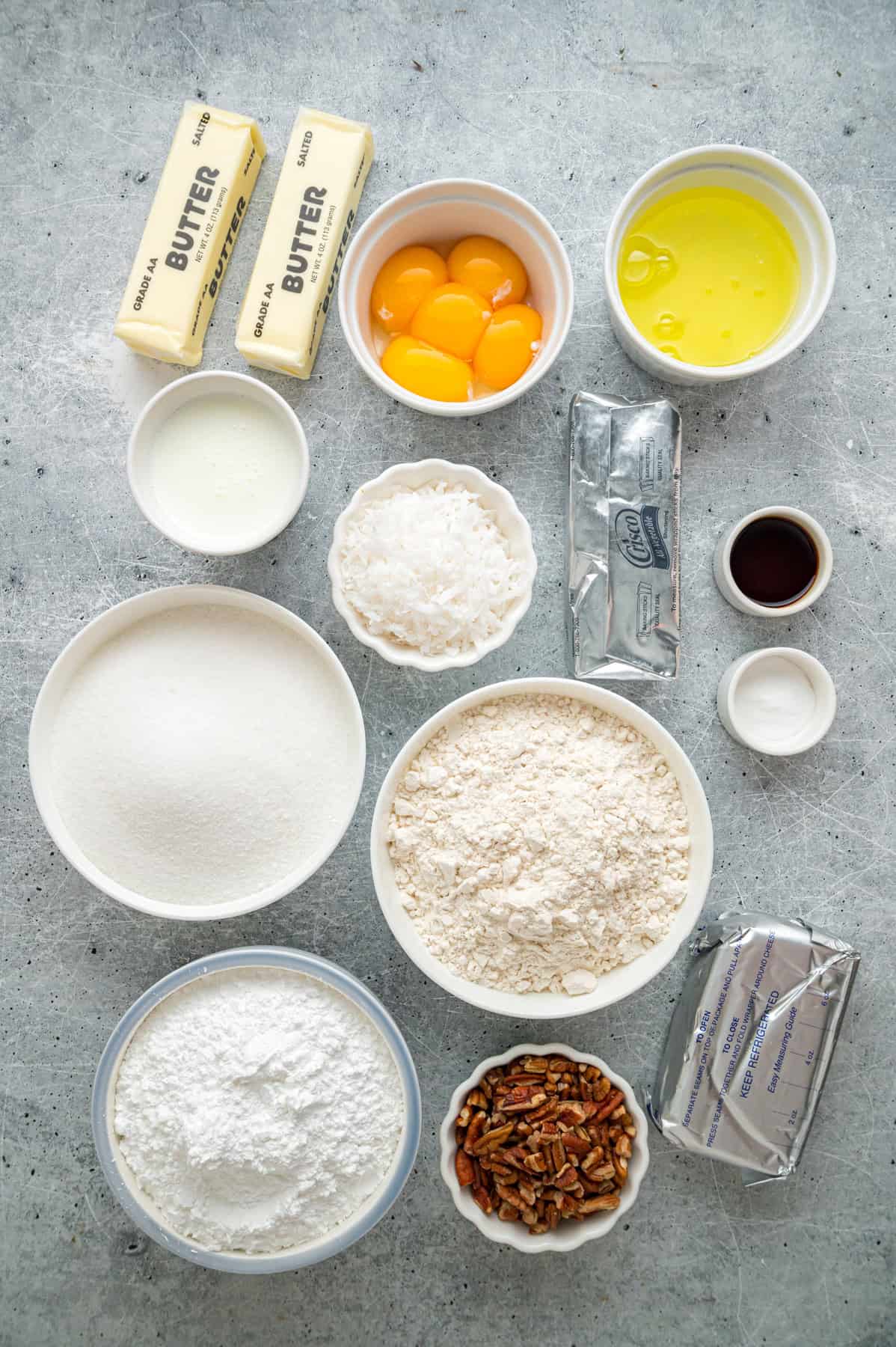 Tender, moist vanilla cake is dotted with coconut and pecans, then topped with cream cheese frosting in this Italian Cream Cake recipe. Overhead view of ingredients needed to make Italian cream cake