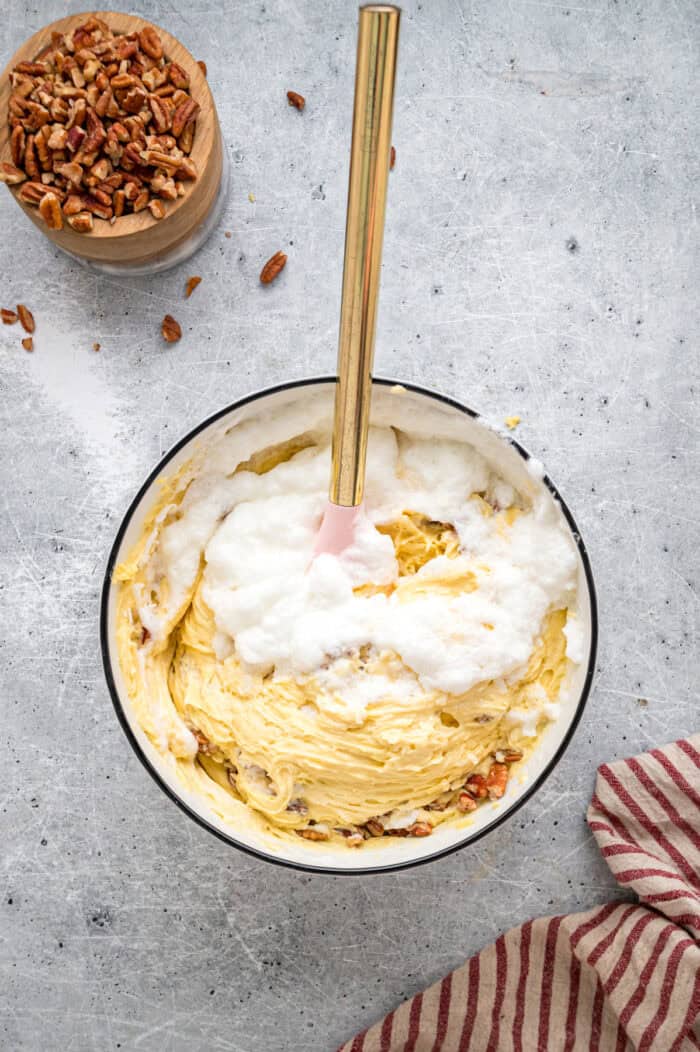 Tender, moist vanilla cake is dotted with coconut and pecans, then topped with cream cheese frosting in this Italian Cream Cake recipe. Folding egg whites into cake batter
