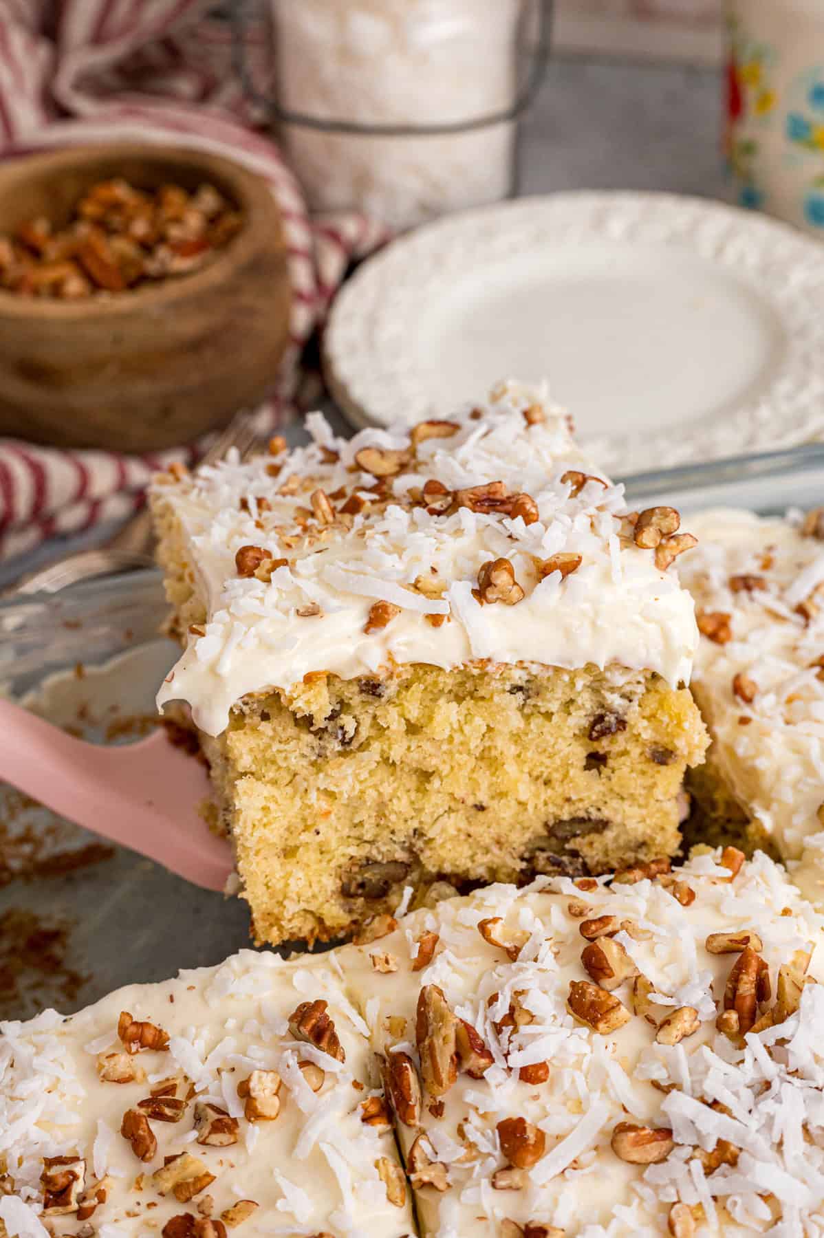 Lifting a slice of Italian cream cake from the pan
