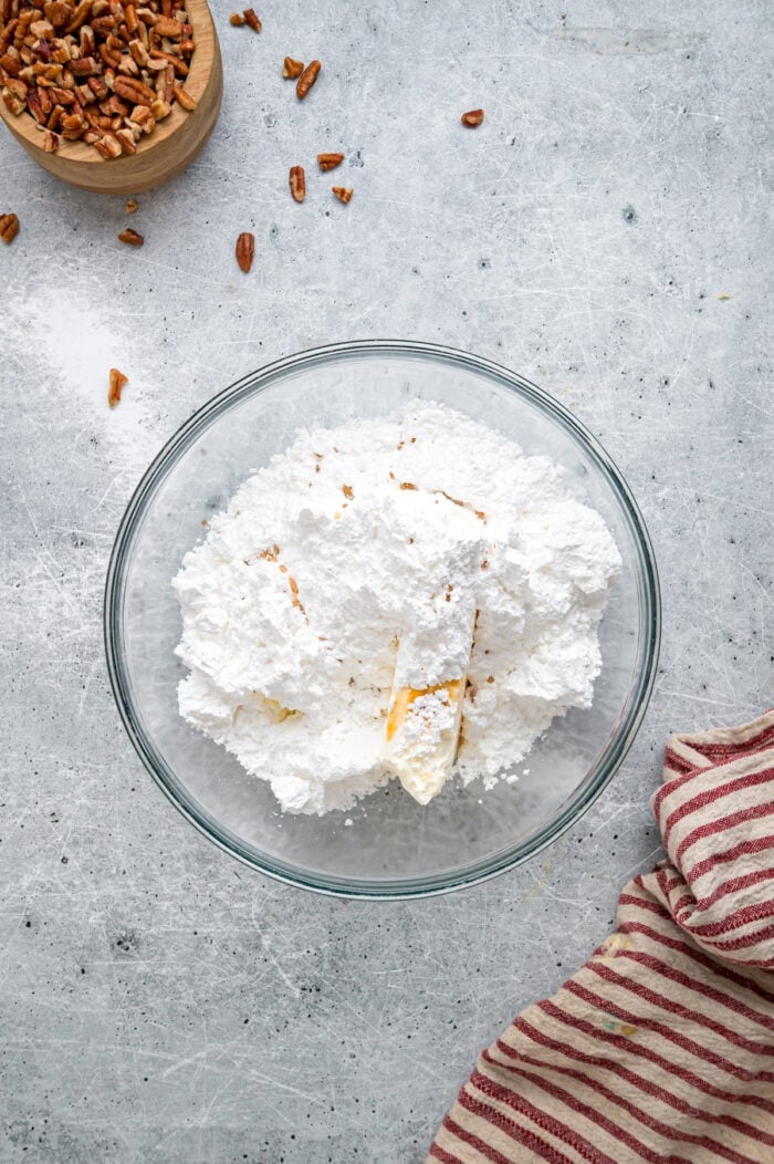 Tender, moist vanilla cake is dotted with coconut and pecans, then topped with cream cheese frosting in this Italian Cream Cake recipe. Powdered sugar added to creamed butter and cream cheese