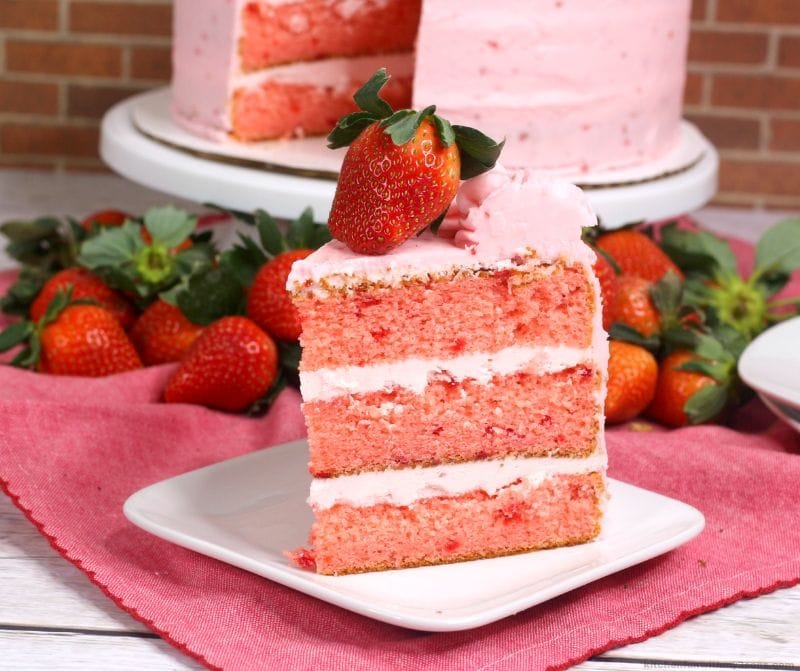 slice of strawberry cake on a square white plate