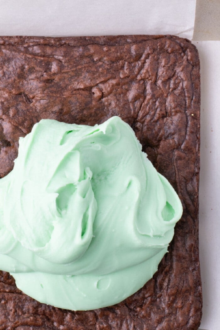 spreading mint frosting over brownies