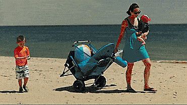 A gif of a transformable wagon rolling across the sand, then being turned into a lounger