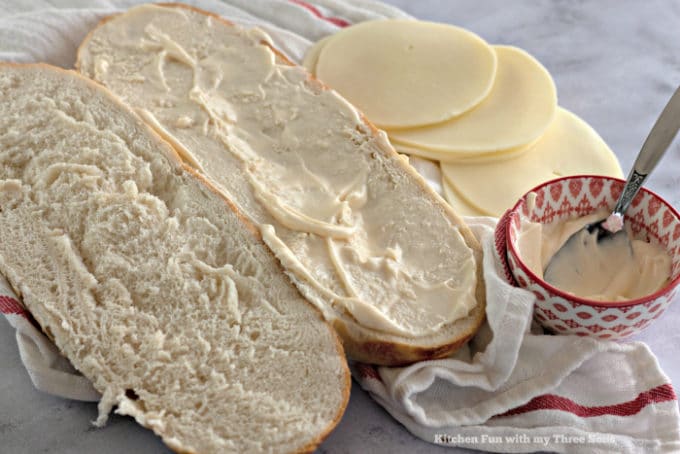 Coating fresh bread with mayonnaise