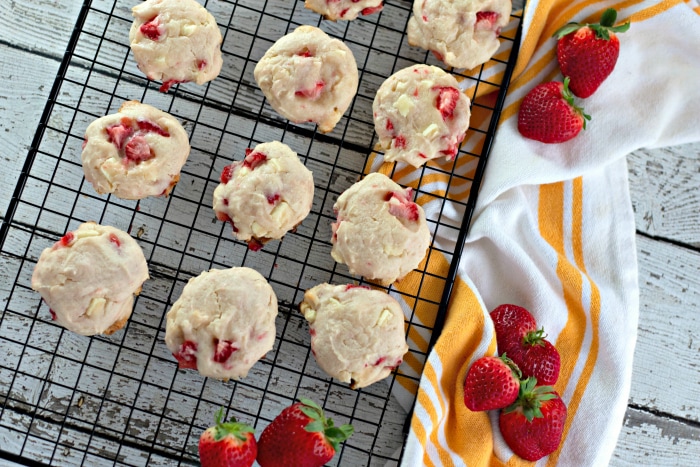 Overhead view of white chocolate strawberry cookies on a wire rack.