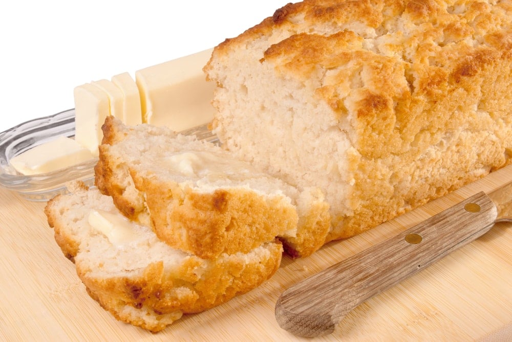 A loaf of beer bread, with a few pieces sliced
