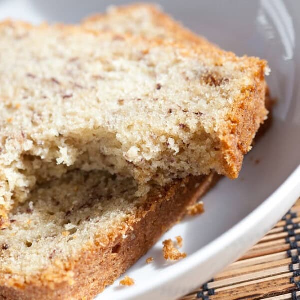 Two slices of banana bread on a white plate