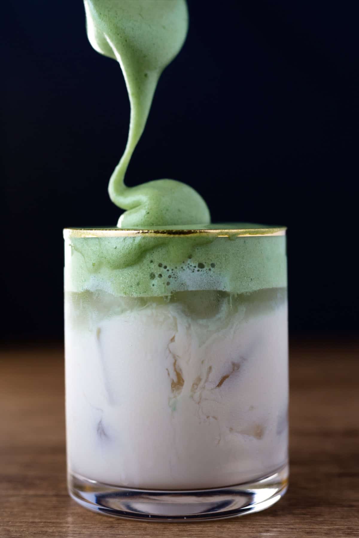 Dalgona coffee, also called "whipped coffee," is known for its light and airy top layer that resembles a coffee flavored fluffy whipped cream. Whipped Match Dalgona Coffee
