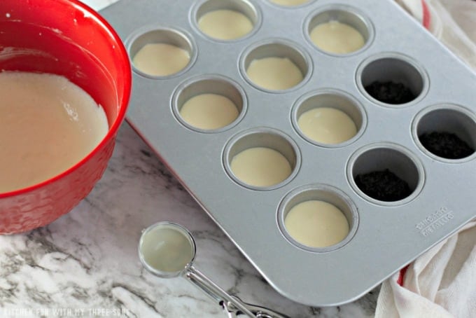 filling a mini cheesecake pan with cheesecake batter