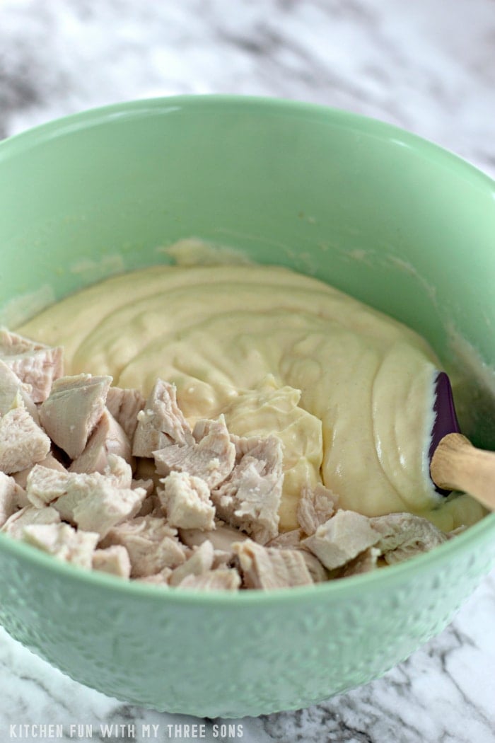Chicken pieces are folded into the cream sauce.