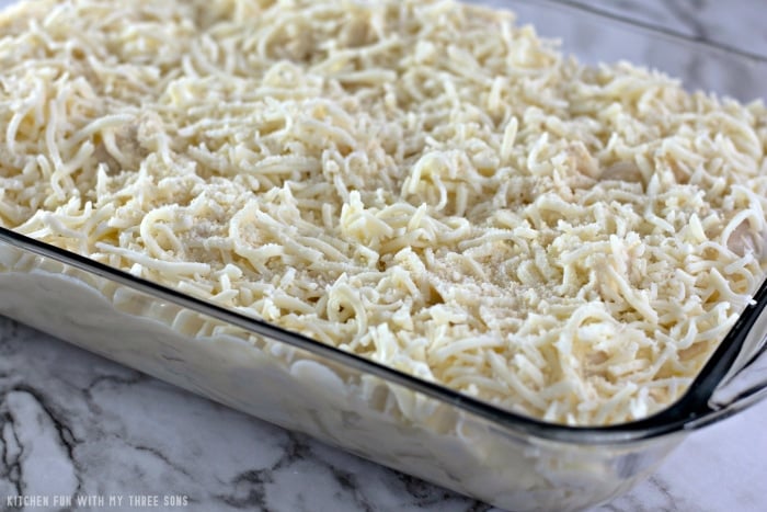 Creamy chicken Tetrazzini topped with mozzarella in a baking dish, ready to be baked.